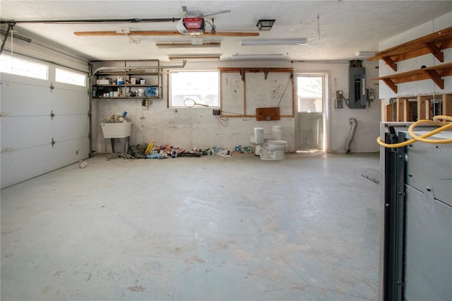 garage with electric panel and a garage door opener