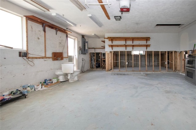 garage with electric panel and a garage door opener