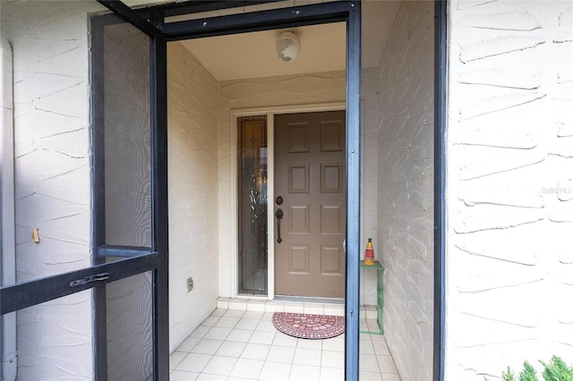 view of exterior entry featuring concrete block siding