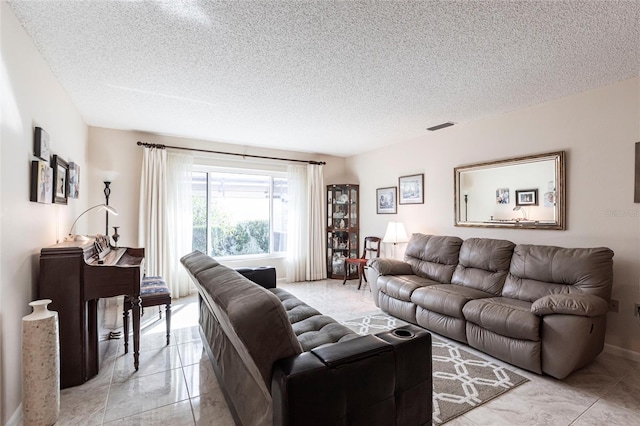 living area featuring a textured ceiling and visible vents