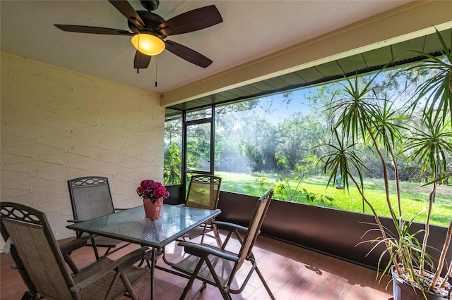 sunroom featuring a ceiling fan