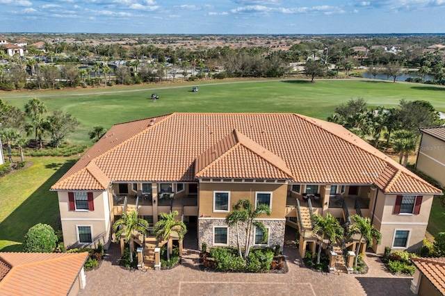 aerial view featuring view of golf course and a water view