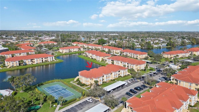 drone / aerial view with a residential view and a water view