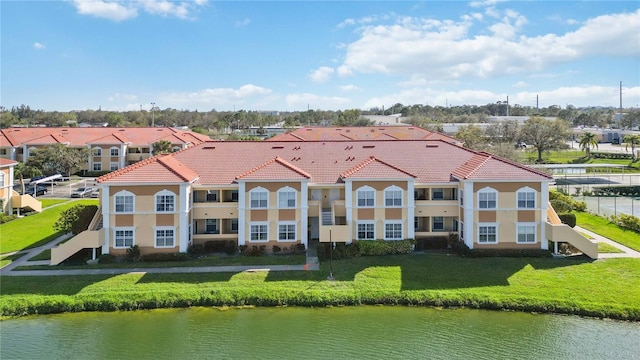 birds eye view of property with a water view and a residential view