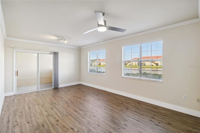 unfurnished bedroom featuring baseboards, wood finished floors, and crown molding