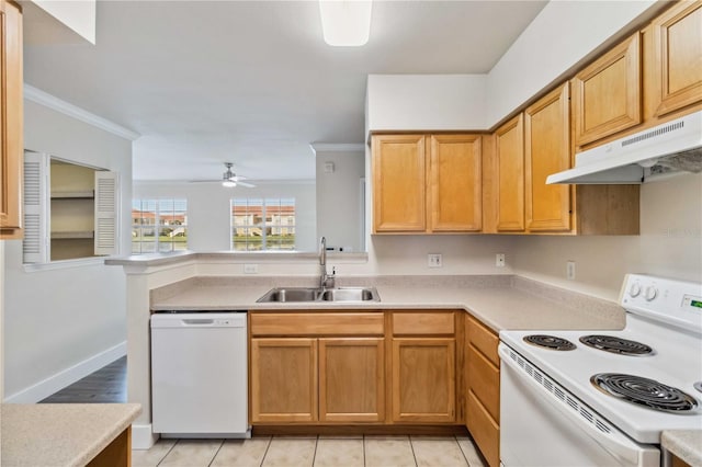 kitchen featuring white appliances, under cabinet range hood, light countertops, and a sink