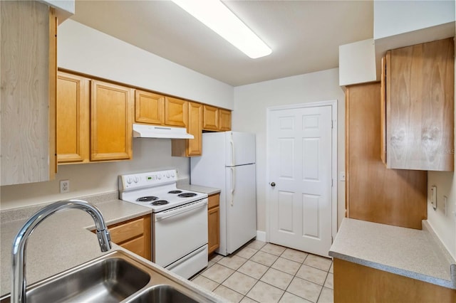 kitchen featuring light tile patterned floors, light countertops, a sink, white appliances, and under cabinet range hood