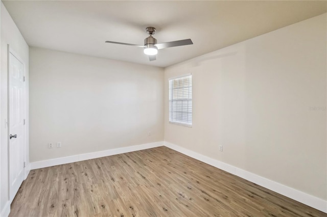 spare room with light wood-style floors, baseboards, and a ceiling fan