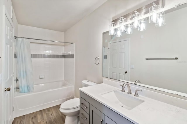 bathroom with vanity, shower / bathtub combination with curtain, toilet, and wood finished floors