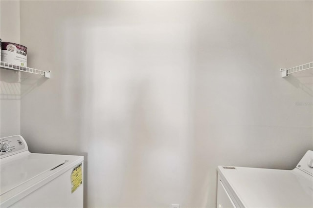 clothes washing area with laundry area and washer and clothes dryer