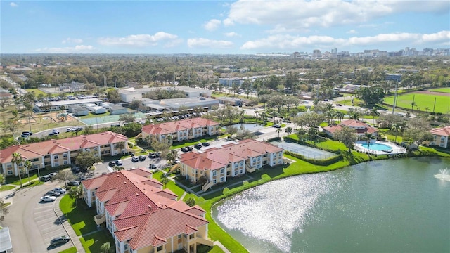 drone / aerial view with a residential view, a water view, and a city view