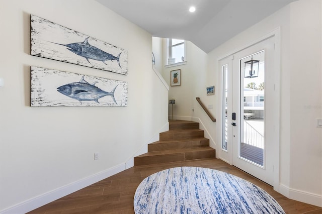 foyer with stairs, baseboards, and dark wood-type flooring