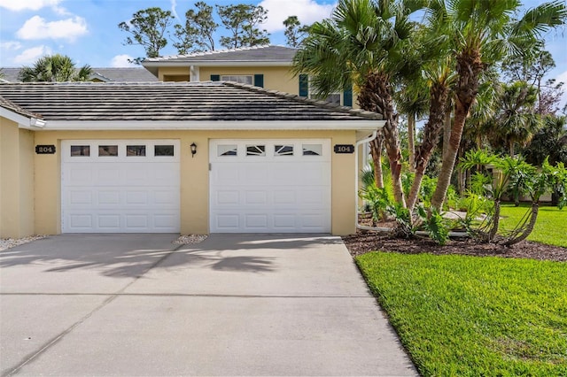 garage featuring concrete driveway