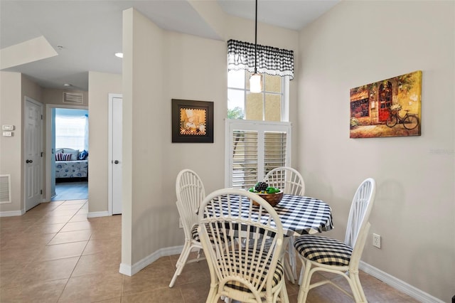 dining area with light tile patterned floors, visible vents, and baseboards