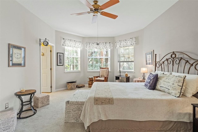 carpeted bedroom featuring baseboards and a ceiling fan