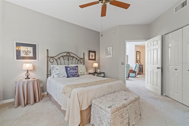 carpeted bedroom featuring visible vents, a closet, and ceiling fan