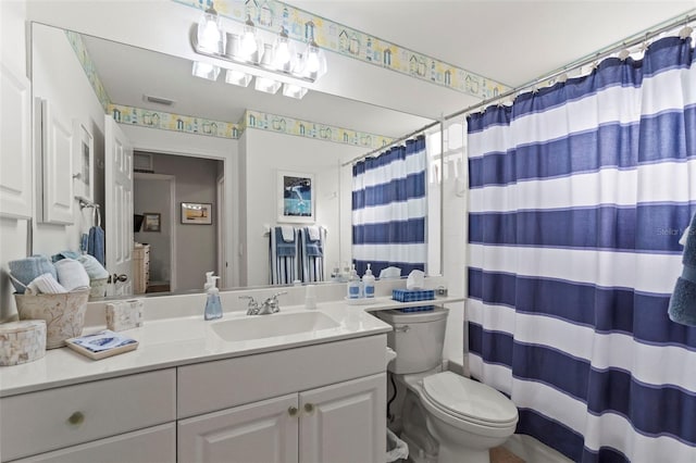 bathroom with visible vents, toilet, vanity, and a shower with curtain