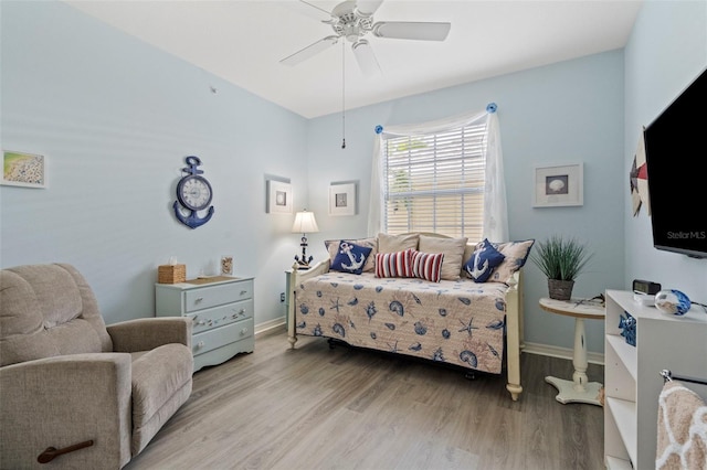 bedroom featuring a ceiling fan, baseboards, and light wood-type flooring