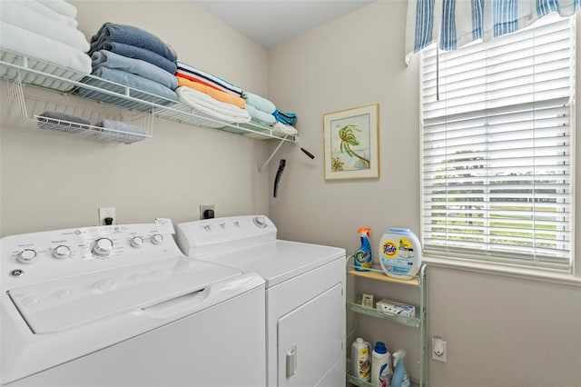 clothes washing area featuring laundry area and washing machine and clothes dryer