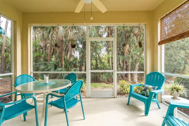 sunroom / solarium with a ceiling fan