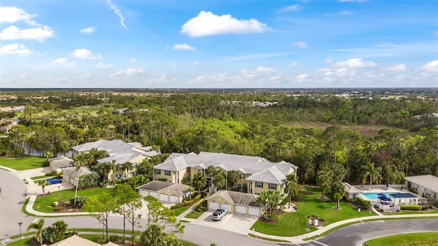 birds eye view of property with a forest view and a residential view