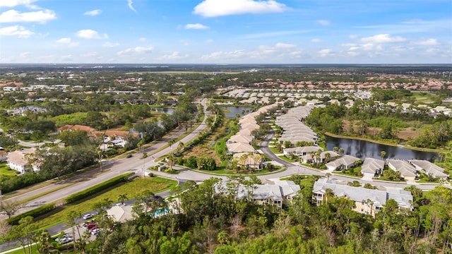 drone / aerial view featuring a residential view and a water view