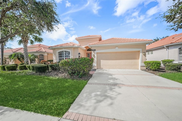 mediterranean / spanish house with stucco siding, a garage, driveway, a tiled roof, and a front lawn