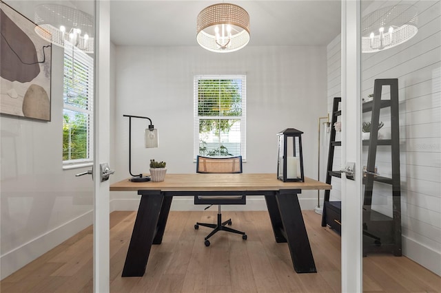 office area featuring a chandelier, french doors, baseboards, and wood finished floors