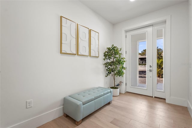 entryway featuring light wood-style flooring and baseboards