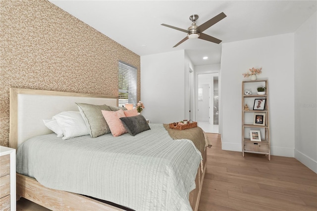 bedroom with a ceiling fan, wood finished floors, recessed lighting, wallpapered walls, and baseboards