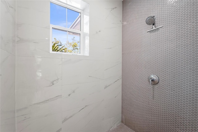 full bath with a tile shower