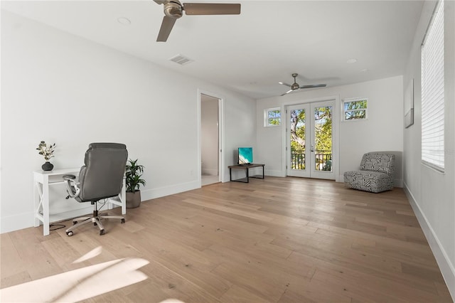 home office featuring visible vents, a ceiling fan, wood finished floors, french doors, and baseboards