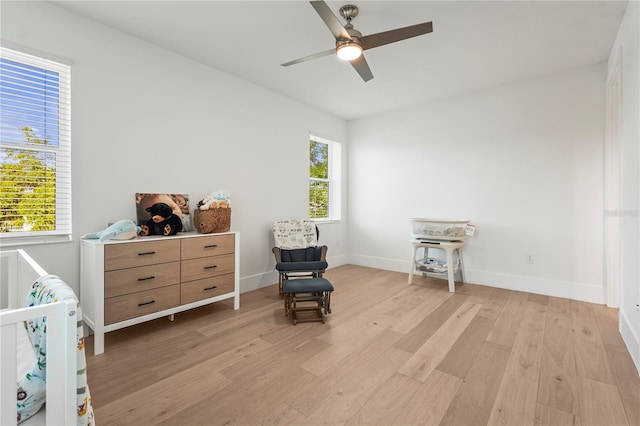 bedroom with baseboards, light wood-style floors, and ceiling fan