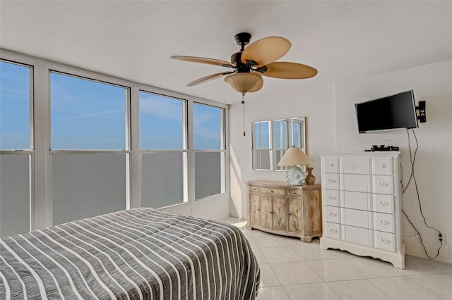 tiled bedroom featuring ceiling fan