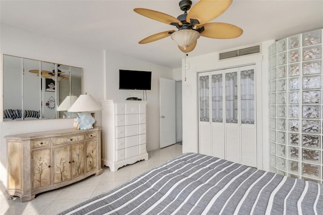 bedroom featuring light tile patterned floors and ceiling fan