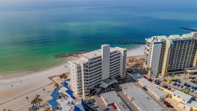 birds eye view of property featuring a water view and a beach view