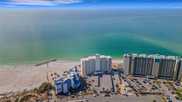 birds eye view of property featuring a water view and a beach view