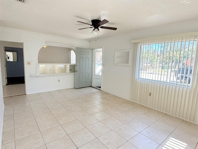 tiled empty room with ceiling fan