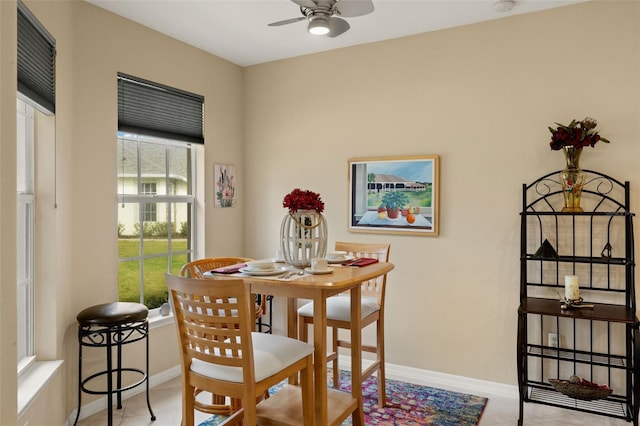 dining room with light tile patterned floors, ceiling fan, and baseboards