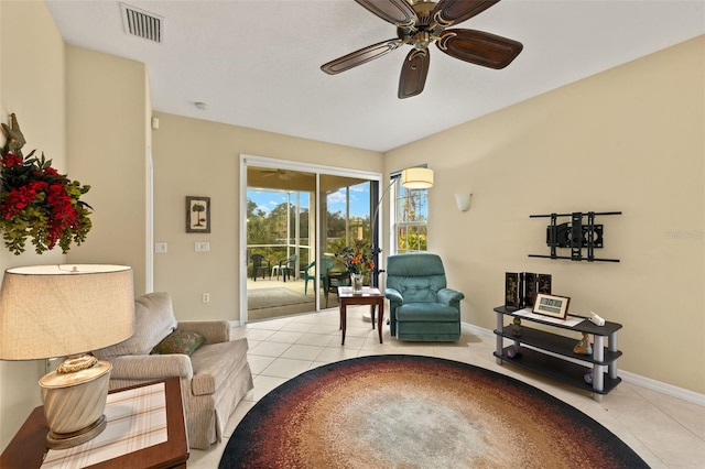 sitting room with visible vents, ceiling fan, baseboards, and light tile patterned floors