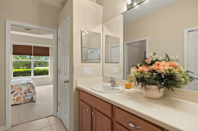 full bath featuring tile patterned flooring, vanity, and ensuite bathroom