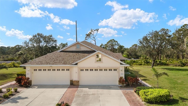 view of front of house featuring driveway, a garage, a shingled roof, a front lawn, and stucco siding