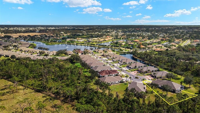 drone / aerial view with a water view and a residential view