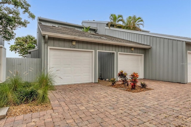 garage featuring decorative driveway