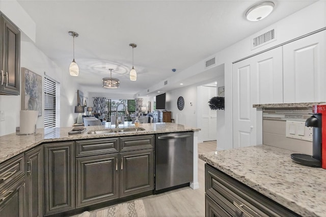 kitchen with dishwasher, a sink, visible vents, and dark brown cabinetry