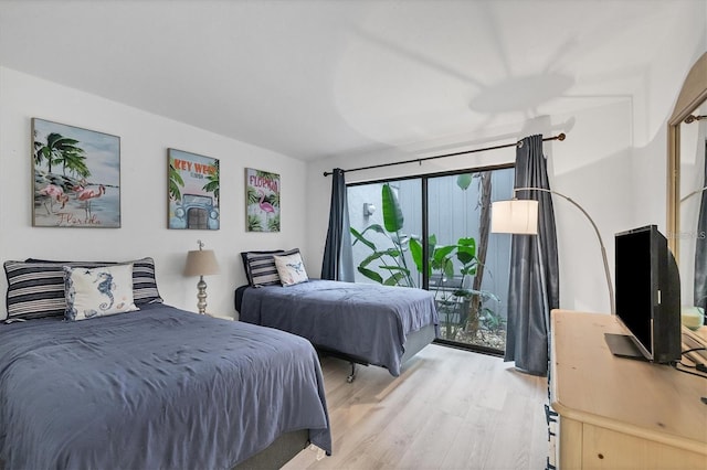 bedroom with light wood-type flooring and access to exterior