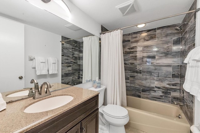 full bath with toilet, vanity, visible vents, and shower / bathtub combination with curtain