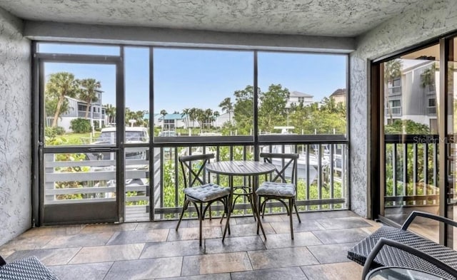 sunroom with a residential view and a healthy amount of sunlight