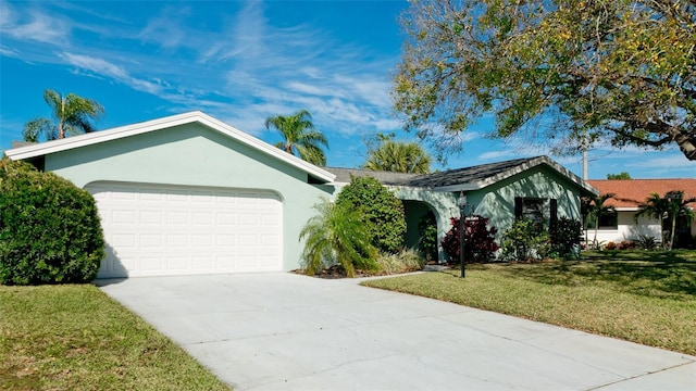 single story home featuring a front lawn and a garage