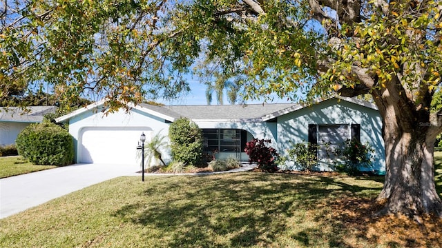 ranch-style home with a garage and a front lawn